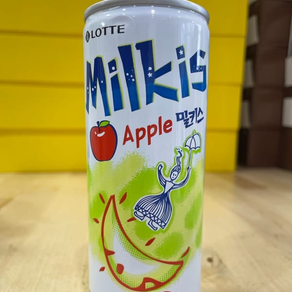 A can of Lotte Milkis Apple flavored soda with a yellow background.