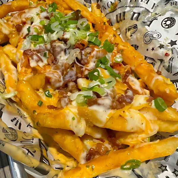 Noori Chicken Ann Arbor's loaded fries, topped with melted cheese, bacon bits, and green onions.