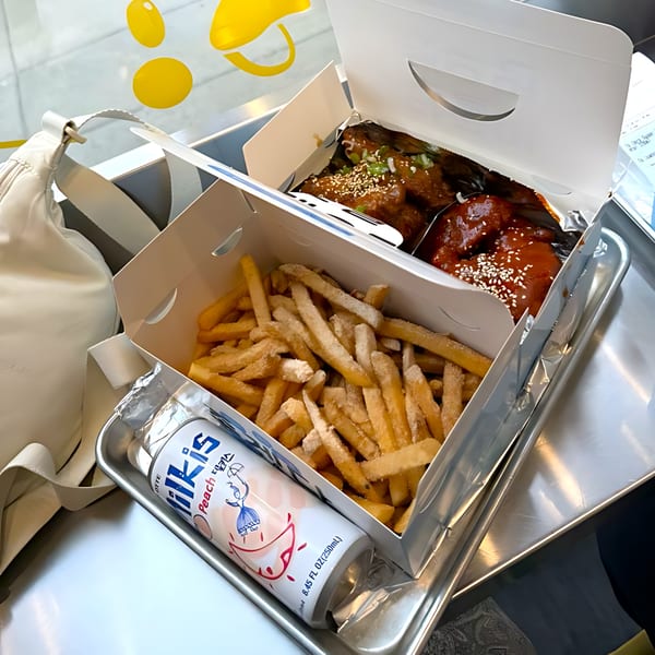 Noori Chicken Ann Arbor takeout boxes with Korean fried chicken, fries, and a peach Milkis drink.